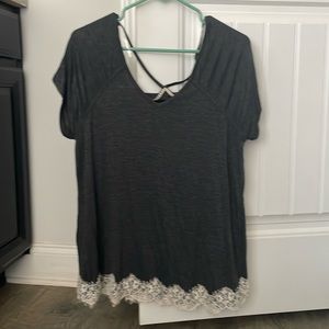 grey shirt with white detailing lining the bottom